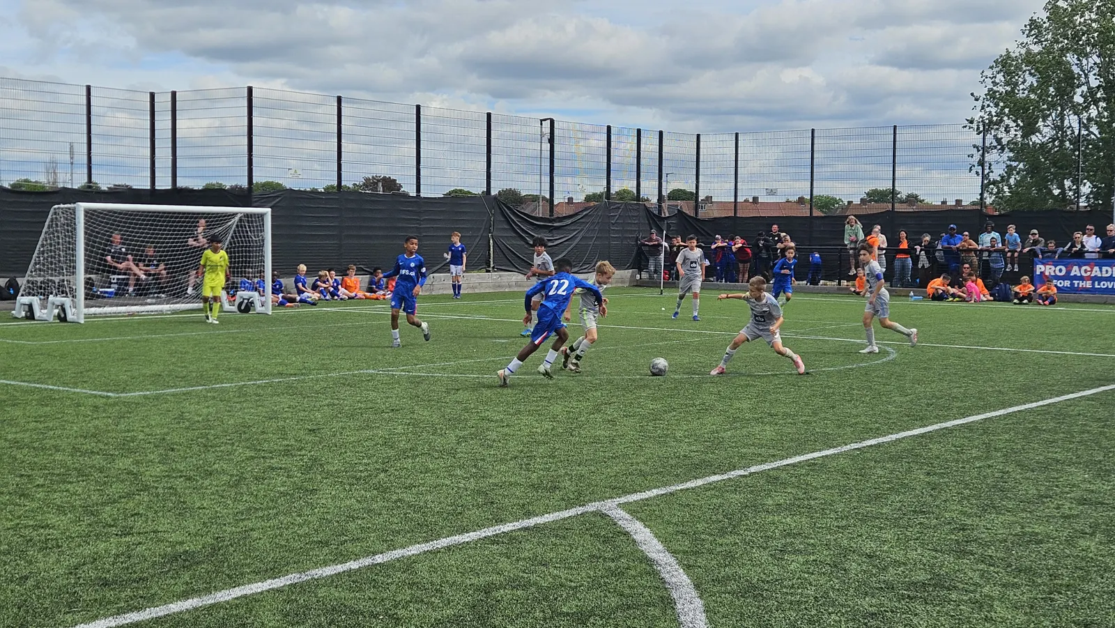 Elle Academy players in grey attacking against a side in blue on a 3G pitch at the Pro Academy Tournament